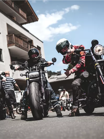 A graphic design for the Newchurch Summit with a focus on the Riders Week and the Riders Weekend. The event takes place in June 2026 and features motifs of mountains and motorcyclists.