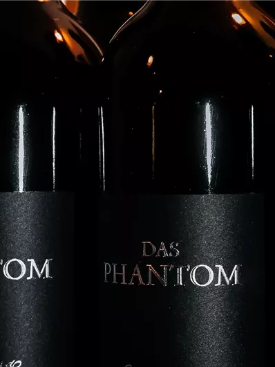 Three bottles of wine with a black label. The label reads "THE PHANTOM".