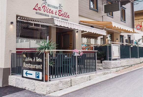 An inviting restaurant named "La Vita e Bella". The facade is welcoming and has a cozy atmosphere.