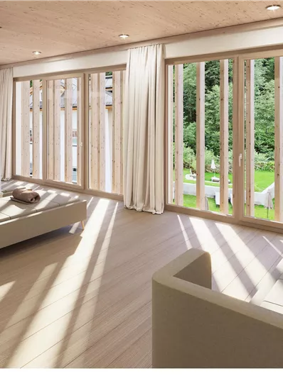 Ein modernes Wohnzimmer mit großen Fenstern und viel Licht. Der Blick zeigt einen grünen Garten und stilvolle Möbel.