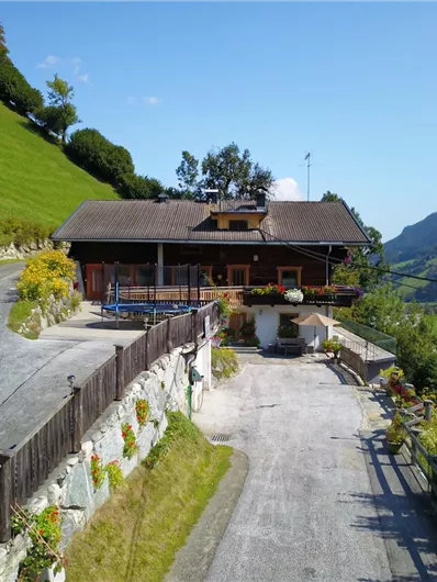 A picturesque house amidst green meadows and gentle hills. The surroundings are quiet and offer a view of the beautiful landscape.
