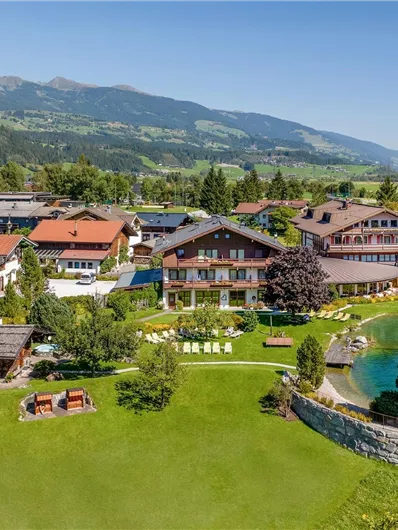 Wanderhotel Kirchner mit großer Gartenanalge, Liegeweise und hoteleigenem Badesee.