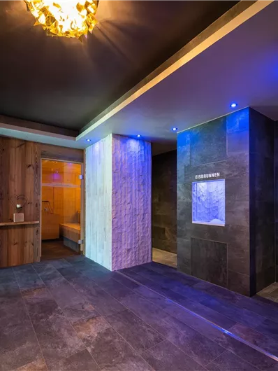 Ein modernes Spa mit stilvollem Design und sanftem Licht. Der Raum verfügt über warme Holzdetails und elegante Fliesen.