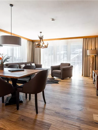 A modern living room with a large dining table and elegant chairs.
Large windows provide plenty of natural light and a cozy atmosphere.